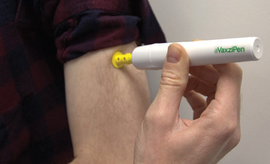 Needle-free aVaxziPen device administering a solid-dose vaccine to a patient's upper arm